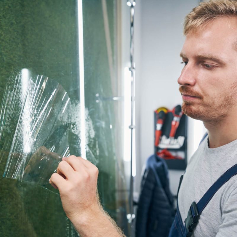 car-service-worker-man-gets-protective-film-closeup-ppf-installation.jpg